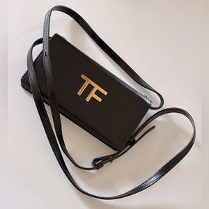 Tom Ford black fold-over wallet on chain.